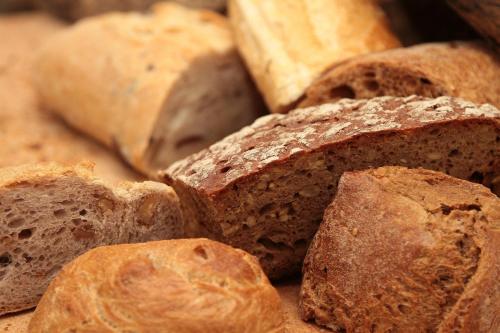 a pile of bread sitting on top of a table at Penzión Restart House - Spiššská Sobota in Poprad