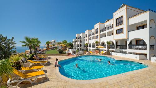 a group of people in a swimming pool at a hotel at Alfagar Cerro Malpique in Albufeira