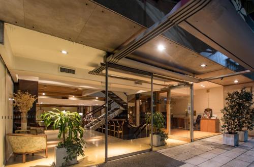 a lobby with glass doors and a staircase in a building at Hotel Solans Carlton in Buenos Aires