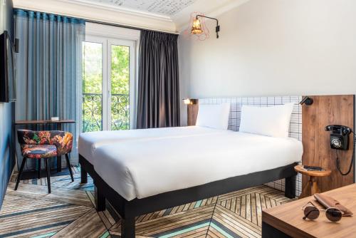 מיטה או מיטות בחדר ב-Ibis Styles Hotel Paris Gare de Lyon Bastille