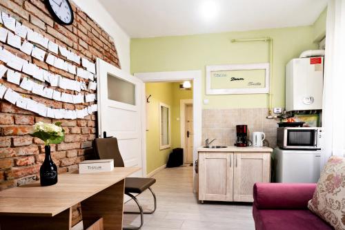 a kitchen and living room with a brick wall at Sunrise Republicii (Old Center) in Braşov