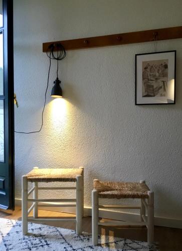 a room with two benches and a light on a wall at Hostal Can Maret in Vilademuls