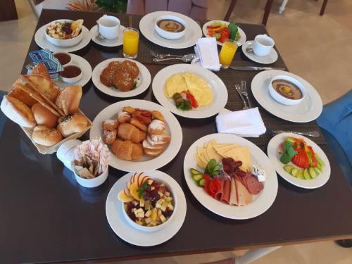 a table with plates of food on it at Golden Jewel Beach&Hotel in Alexandria