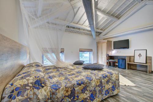 a bedroom with a large bed and a television at Resilienza in Mira