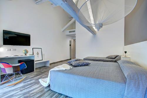 a bedroom with a bed and a desk and a television at Resilienza in Mira