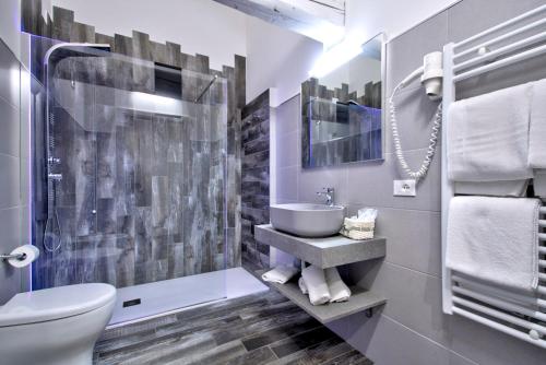 a bathroom with a toilet and a sink and a shower at Resilienza in Mira