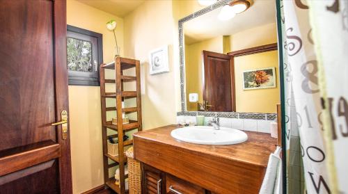 a bathroom with a sink and a mirror at Villa Ana in Costa Teguise