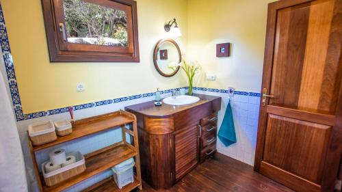 a bathroom with a sink and a mirror at Villa Ana in Costa Teguise