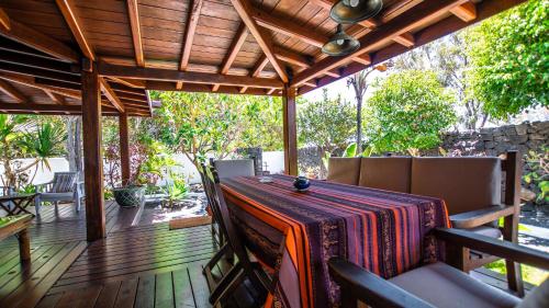 a patio with a table and chairs on a deck at Villa Ana in Costa Teguise