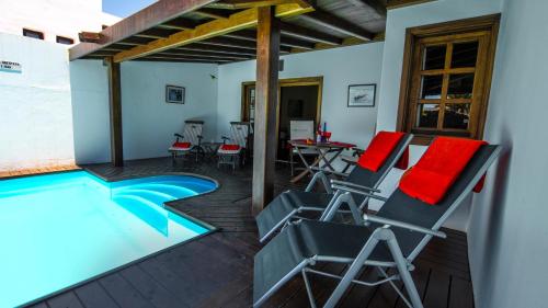 a patio with chairs and a swimming pool at Villa Ana in Costa Teguise