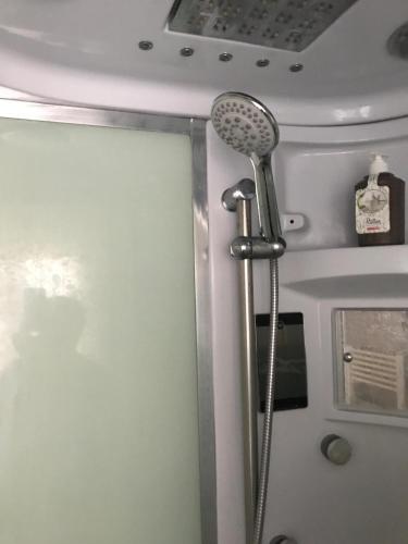 a shower in a bathroom with a shower head at Residenza Parco Gioeni in Catania