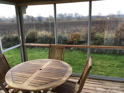 a table and two chairs in front of a window at Nordanå Gård in Strö
