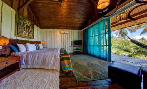 a bedroom with a bed and a tv in a room at Hotel Casa dos Arandis in Marau