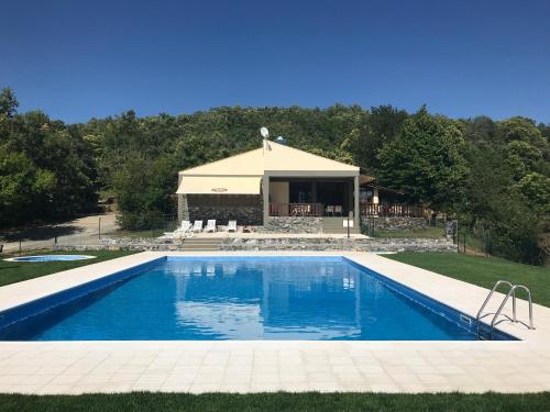 a swimming pool in front of a house at Micro Cabana Rotativa in Bragança