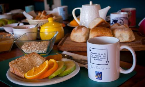 a table with a plate of bread and a cup of coffee at Patagonia Jazz Hostel in San Carlos de Bariloche
