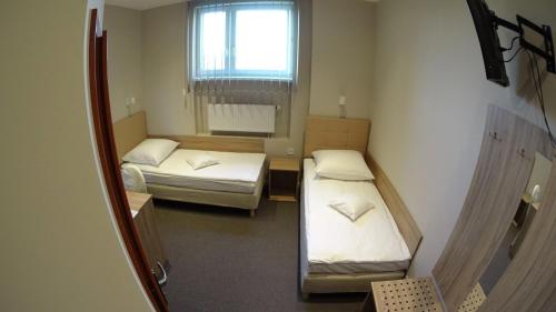 Postel nebo postele na pokoji v ubytování Hotel Astra