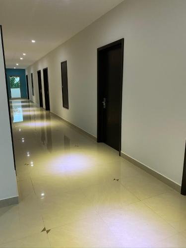 a hallway with a black door and a hallway of rooms at Hotel Ambra in Playa del Carmen