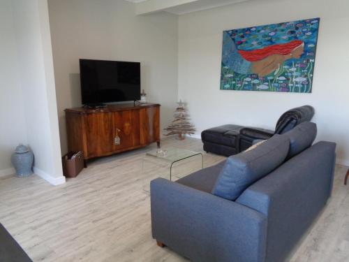 a living room with a couch and a flat screen tv at Erwins Lagoon Retreat in Beachport