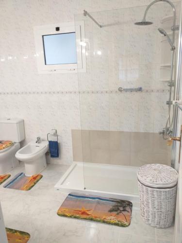 a bathroom with a shower and a toilet at Sun & Sol in Caleta De Fuste