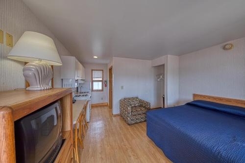 a bedroom with a bed and a tv in a room at Sea Spray Motel in Beach Haven
