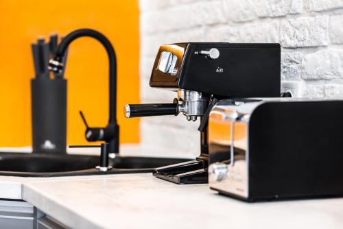 a sewing machine sitting on a counter in a kitchen at Apartment Orange Dream in Gdańsk