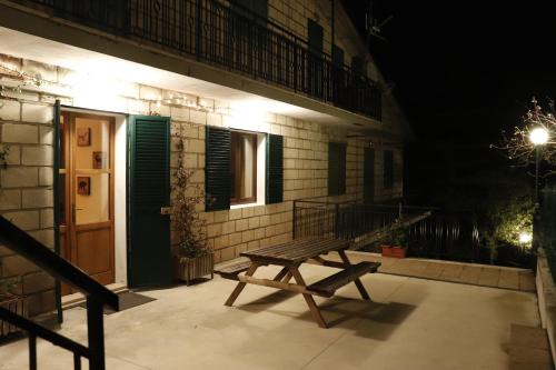 a wooden bench sitting outside of a building at night at Lupus Domum in Pretoro