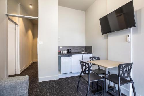 a kitchen and dining room with a table and chairs at Nightcap at Sylvania Hotel in Campbellfield