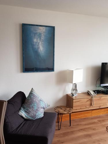 a living room with a couch and a tv at Graf's Apartment Sankt Englmar in Sankt Englmar