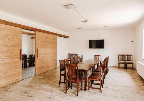 a dining room with a table and chairs at Farma Klokočov in Vítkov