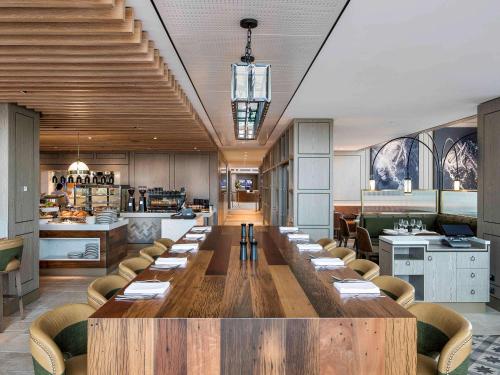a large dining room with a long table and chairs at The William Inglis Mgallery in Warwick Farm