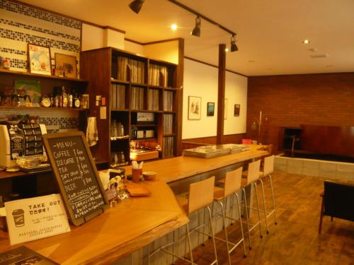 a bar in a restaurant with a counter and chairs at Youth Hostel WANIHAMA-Beach side Lake BIWA in Otsu