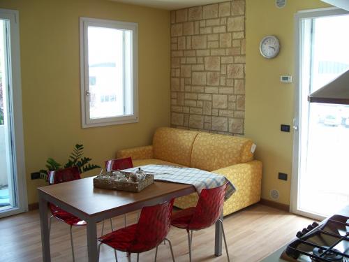 a living room with a table and a couch at Ely'S Residence in Romano D'Ezzelino
