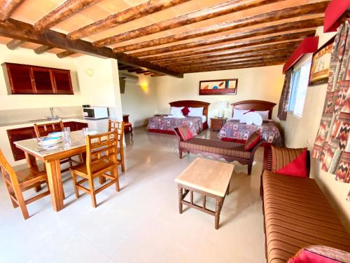 a living room with a couch and a table at Hotel El Campanario Playa del Carmen in Playa del Carmen