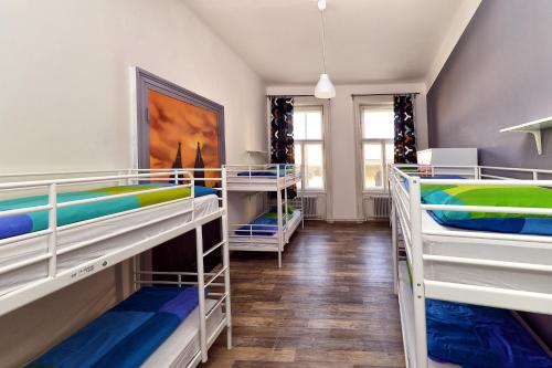 a dorm room with three bunk beds in it at Onefam Home in Prague