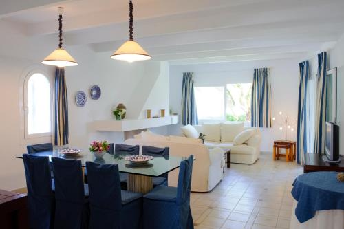 a living room with a couch and a table at Villa Acebuche in Cala d´Or