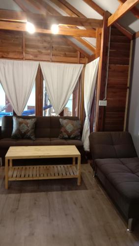 a living room with a couch and a table at Lazy Hut in Ko Phayam