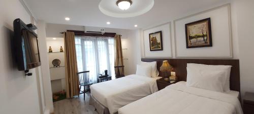 Ліжко або ліжка в номері Hanoi Endless Hotel