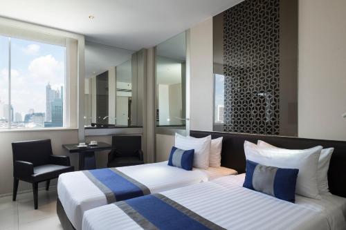 En eller flere senge i et værelse på Mandarin Hotel Managed by Centre Point