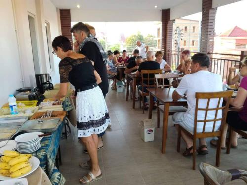 a woman standing at a table in a restaurant at avalon residence2 in Savannakhet