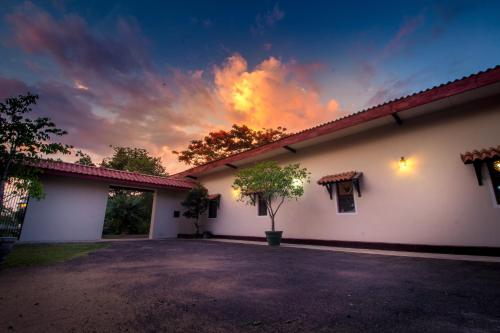 a building with a sunset in the sky at The Buena Vista Kandy in Kandy