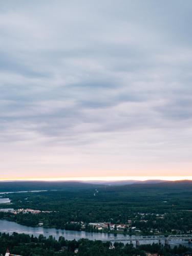 an aerial view of a river and a city at Lapland Hotels Sky Ounasvaara in Rovaniemi