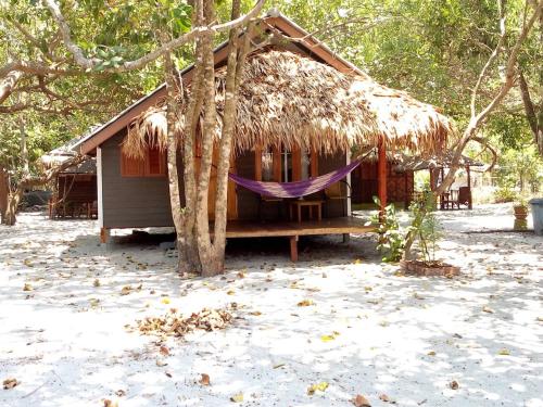 a small hut with a thatched roof at Lazy Hut in Ko Phayam