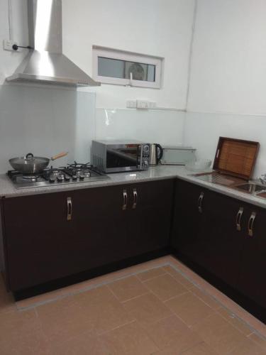 a kitchen with a stove and a counter top at Les Antigones in Crève Coeur
