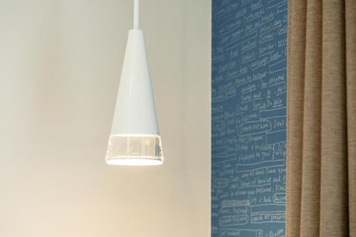 a light hanging from a wall next to a curtain at M's Hotel Kyoto Station Kizuya in Kyoto