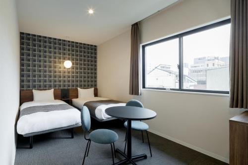 Postel nebo postele na pokoji v ubytování M's Hotel Kyoto Station Kizuya