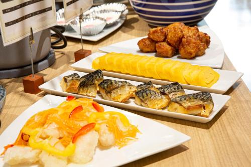 three plates of food on a table with food at Place Hotel Ascot in Kumamoto