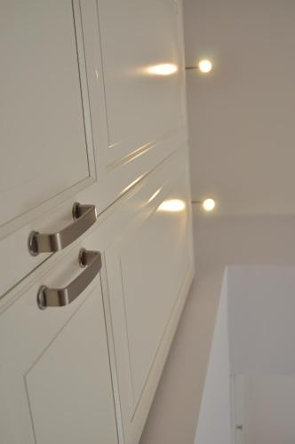a white kitchen cabinet with a glass door at Casa Martini in Rome