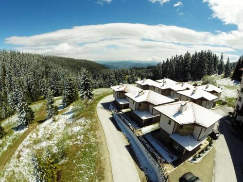 an aerial view of a house with snow covered roofs at Forest Nook Villas in Pamporovo