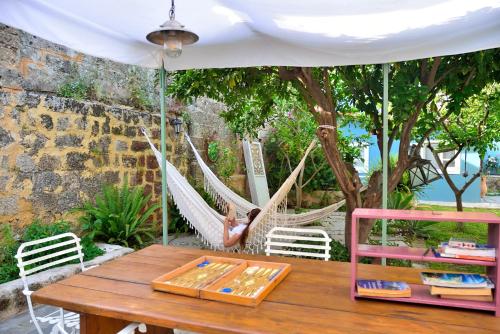 a girl in a hammock in a garden at Aria di Rodi in Rhodes Town