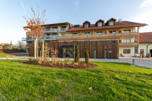 a large building with a lawn in front of it at Landrefugium Obermüller 4,5 Sterne in Untergriesbach